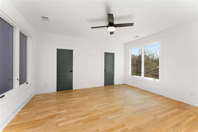 unfurnished bedroom with visible vents, baseboards, light wood-style floors, and a ceiling fan