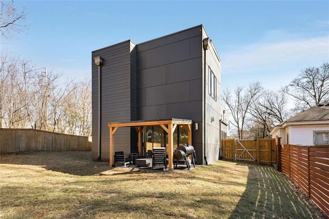 view of outdoor structure featuring a fenced backyard and a gate