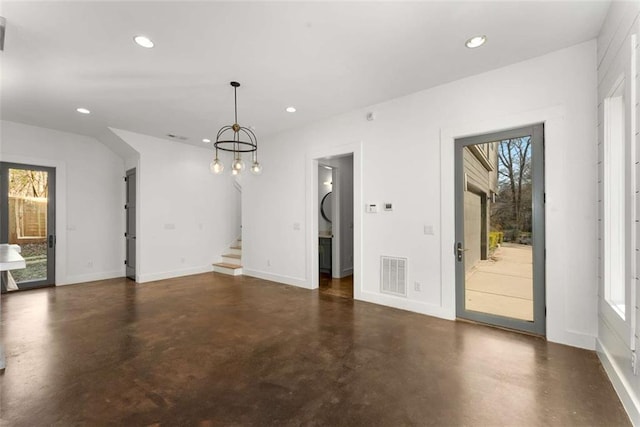 unfurnished dining area with visible vents, finished concrete flooring, recessed lighting, baseboards, and stairs