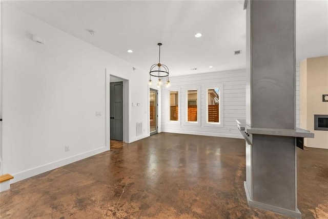 unfurnished living room with finished concrete floors, recessed lighting, baseboards, and visible vents