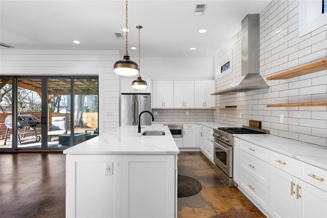 kitchen with a sink, finished concrete floors, appliances with stainless steel finishes, wall chimney exhaust hood, and open shelves