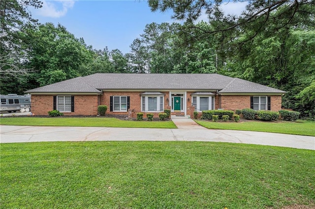 3003 Hanover Ln SE, Conyers, GA 30094 - ranch-style home with brick siding, a front lawn, and a shingled roof
