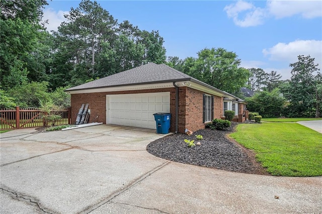 3003 Hanover Ln SE, Conyers, GA 30094 - view of side of property with brick siding, driveway, an attached garage, and view of scattered trees