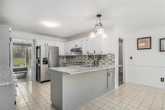 3003 Hanover Ln SE, Conyers, GA 30094 - kitchen with stainless steel refrigerator with ice dispenser, light tile patterned floors, a peninsula, light stone counters, and ornamental molding