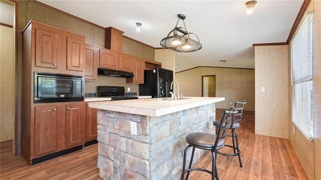 88 Turner Rd, Jasper, GA 30143 - kitchen with brown cabinetry, ornamental molding, a chandelier, pendant lighting, and wood finished floors
