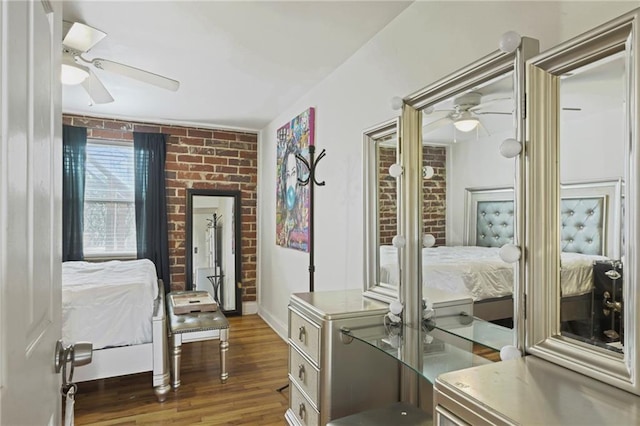 bedroom featuring wood finished floors, a ceiling fan, and baseboards