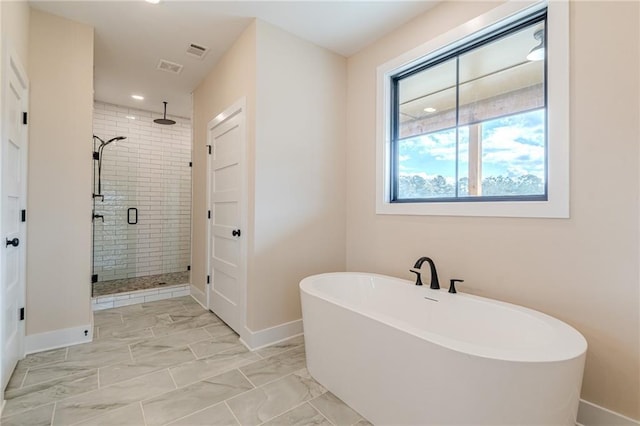 bathroom with shower with separate bathtub