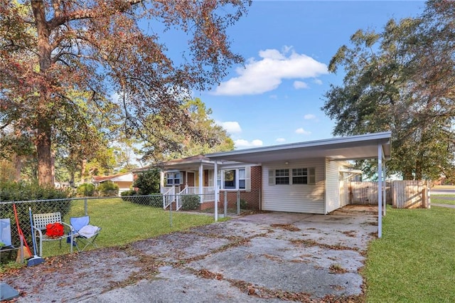 ranch-style house featuring a front yard and a carport