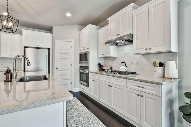 kitchen featuring white cabinetry, decorative light fixtures, decorative backsplash, and appliances with stainless steel finishes