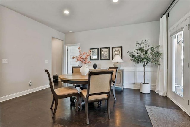 dining room with a wealth of natural light and dark hardwood / wood-style floors