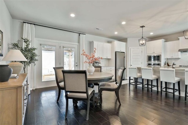 dining room featuring dark hardwood / wood-style flooring and french doors