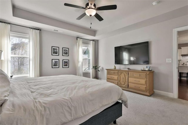 bedroom with multiple windows, ceiling fan, and carpet flooring