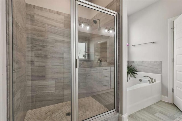 bathroom featuring separate shower and tub