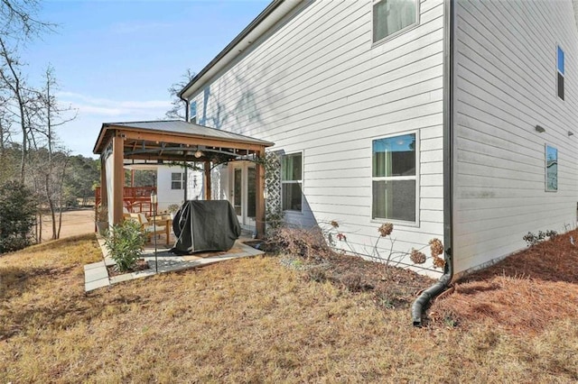 view of home's exterior with a gazebo and a yard