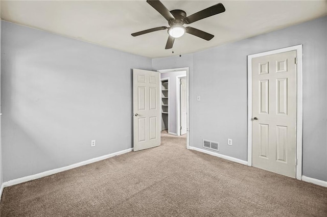 unfurnished bedroom featuring light carpet and ceiling fan