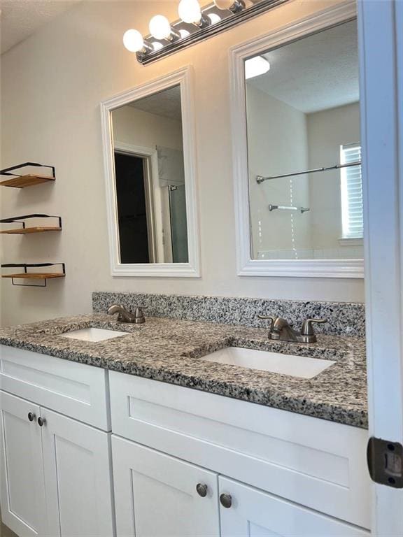 bathroom featuring vanity and an enclosed shower