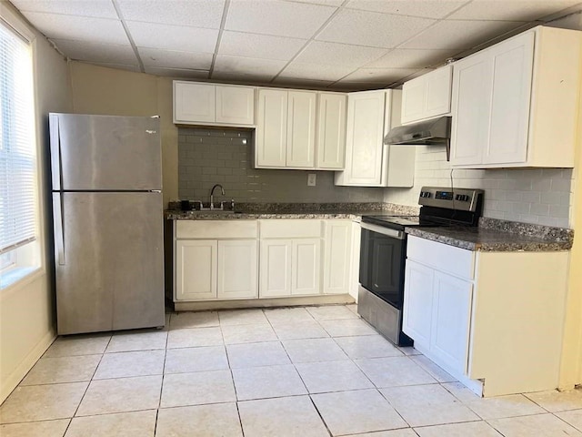 kitchen featuring white cabinets, appliances with stainless steel finishes, light tile patterned floors, and sink