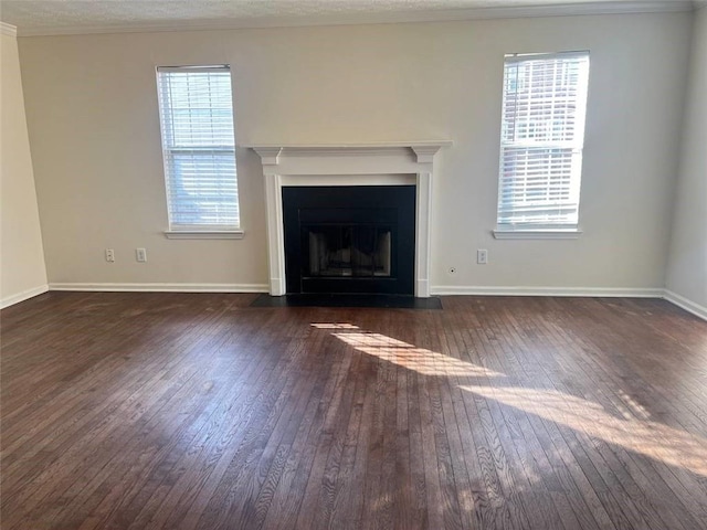 unfurnished living room with crown molding and dark wood-type flooring