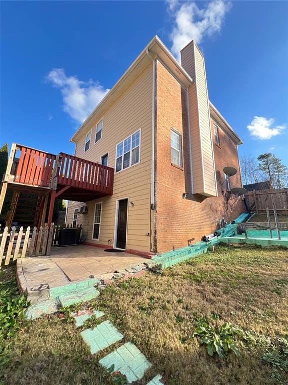 back of house featuring a pool side deck, a patio, and central AC