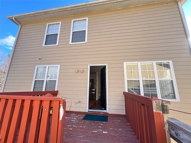 back of house with a wooden deck