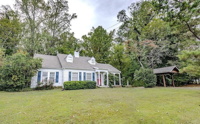 new england style home featuring a front yard