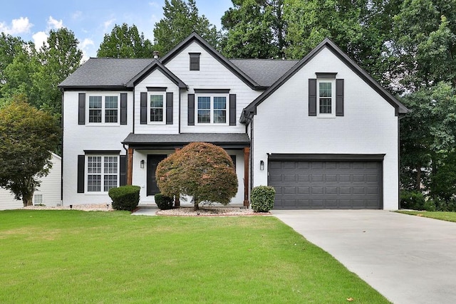 view of front of home with a front yard and a garage