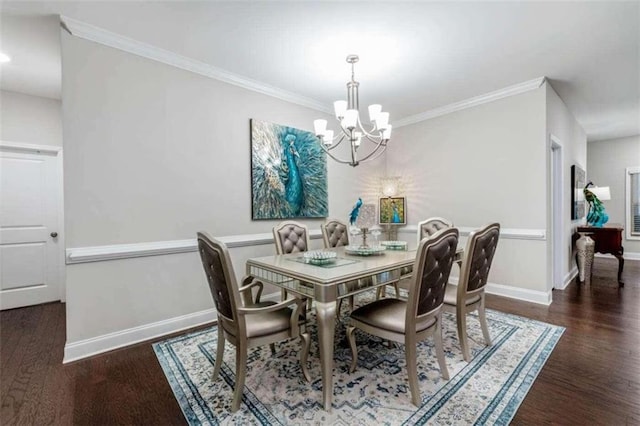 dining area with dark hardwood / wood-style flooring, crown molding, and an inviting chandelier