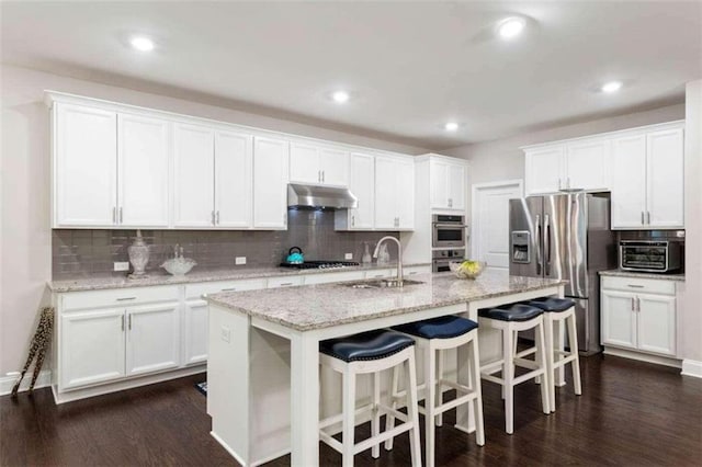 kitchen with white cabinets, an island with sink, stainless steel appliances, and sink