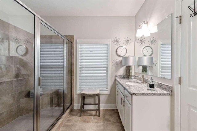 bathroom with tile patterned floors, an enclosed shower, and vanity