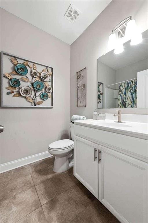 bathroom with toilet, vanity, and a shower with shower curtain