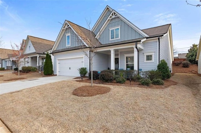 craftsman inspired home featuring a garage and covered porch