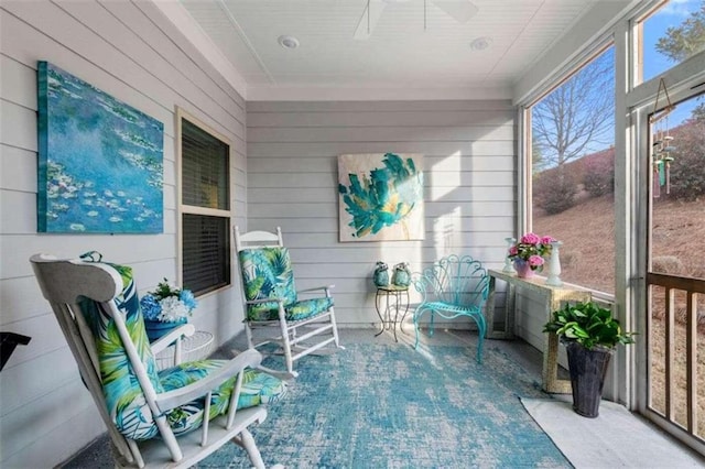 sunroom / solarium featuring ceiling fan