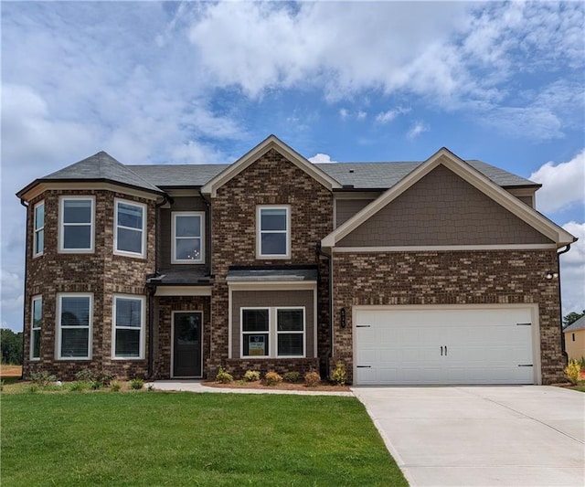 view of front of house with a garage and a front lawn