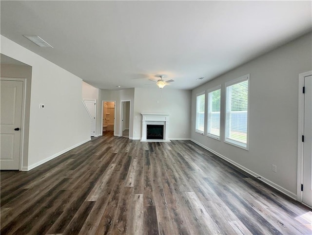 unfurnished living room with dark hardwood / wood-style floors and ceiling fan