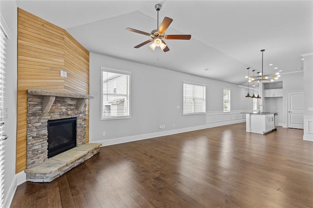 6469 Crosscreek Ln, Flowery Branch, GA 30542 - unfurnished living room with vaulted ceiling, a fireplace, dark wood finished floors, healthy amount of natural light, and ceiling fan