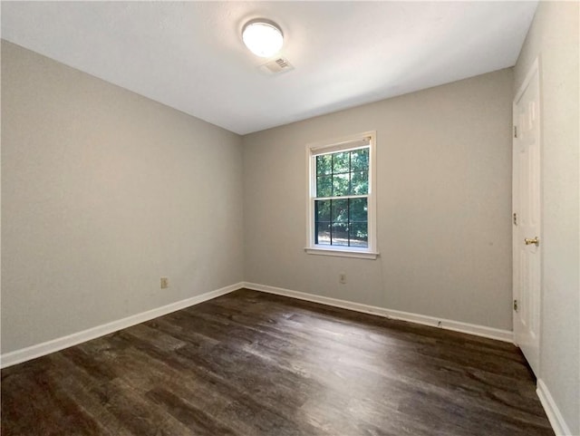 unfurnished room with dark hardwood / wood-style floors