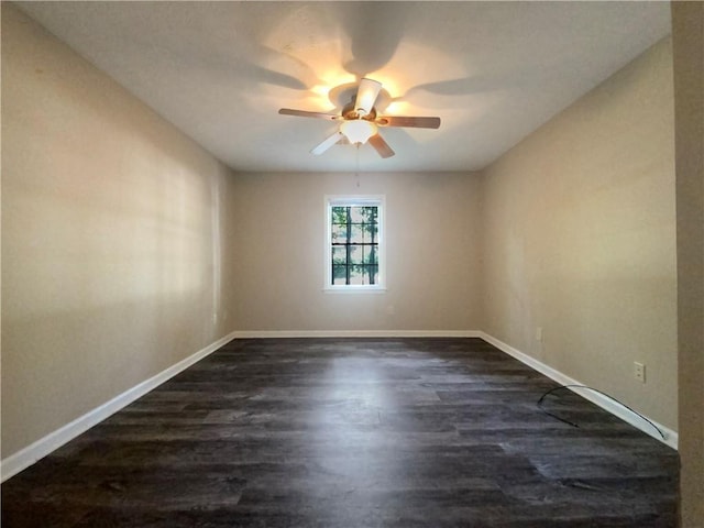 empty room featuring ceiling fan and dark hardwood / wood-style floors