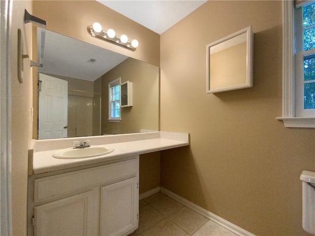 bathroom with walk in shower, tile patterned flooring, vanity, and toilet