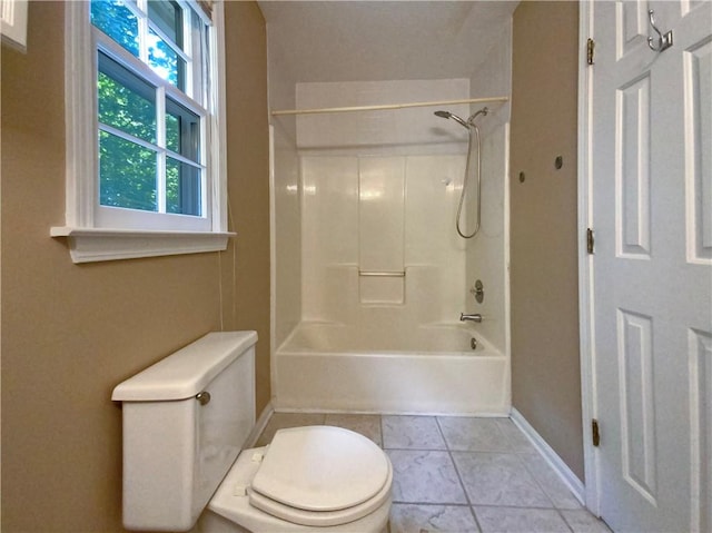 bathroom with bathtub / shower combination, toilet, and tile patterned floors