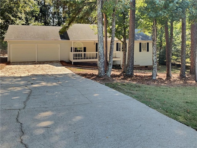 view of front of house featuring a porch and a garage