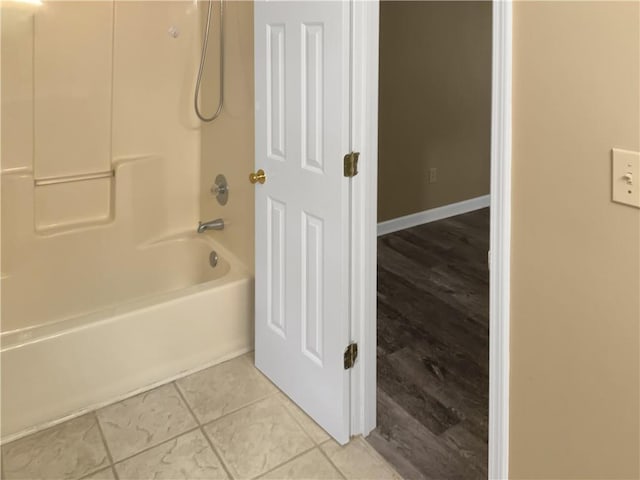 bathroom with shower / washtub combination and wood-type flooring