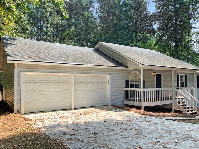 single story home with a porch and a garage