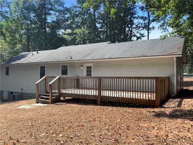 back of house featuring central air condition unit and a wooden deck