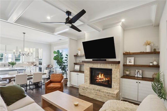 living room featuring beam ceiling, a brick fireplace, ceiling fan with notable chandelier, dark wood-style floors, and coffered ceiling