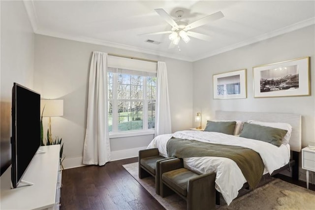 bedroom with ceiling fan, visible vents, crown molding, dark wood finished floors, and baseboards