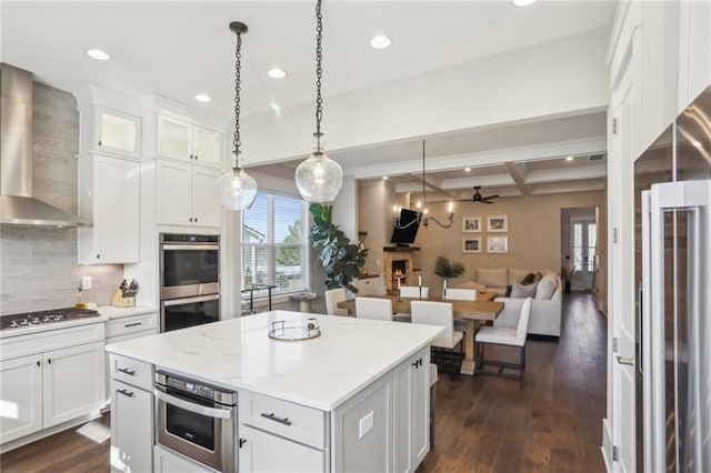 kitchen featuring decorative backsplash, recessed lighting, wall chimney exhaust hood, coffered ceiling, and stainless steel appliances