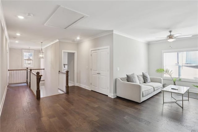 living area with dark wood finished floors, baseboards, ornamental molding, and recessed lighting