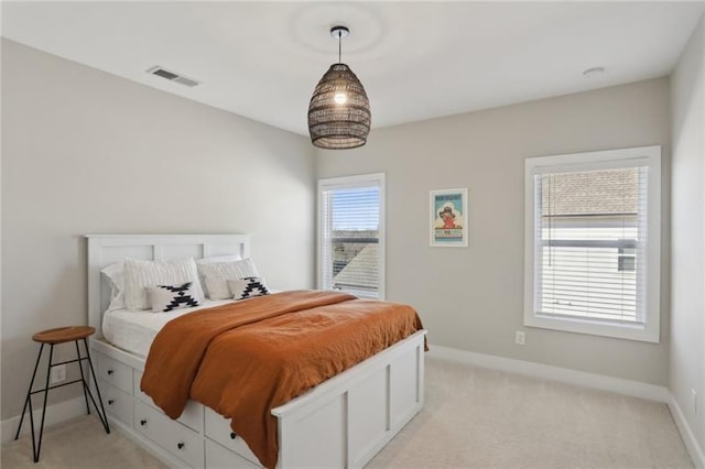 bedroom featuring light colored carpet, baseboards, and visible vents