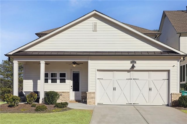 view of front facade with an attached garage, a ceiling fan, a standing seam roof, and concrete driveway