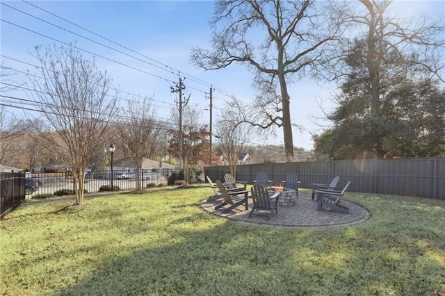 view of yard with a patio, a fire pit, and a fenced backyard